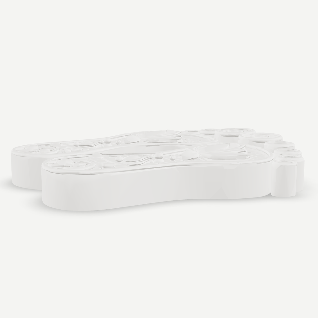3D printed decorative paduka pair — low angle view