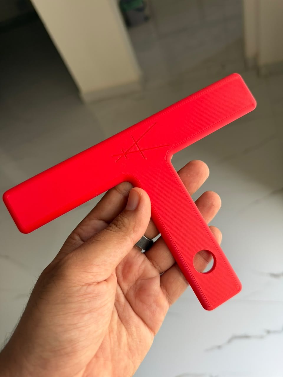 Red T Mark MK-i held in hand